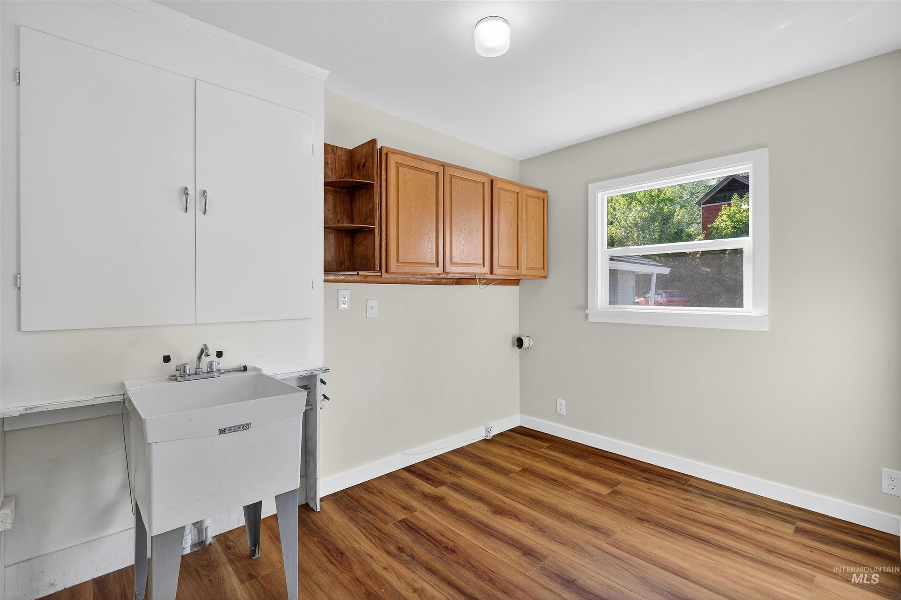 164 State Street Juliaetta, ID 83535 - Photo 20 of 37 Washroom with dark wood-type flooring and cabinet space