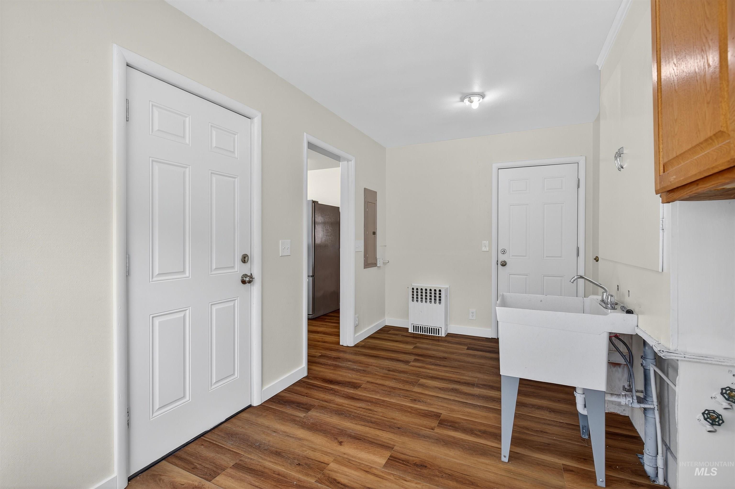 164 State Street Juliaetta, ID 83535 - Photo 21 of 37 Washroom featuring dark wood-style flooring, radiator, and cabinet space
