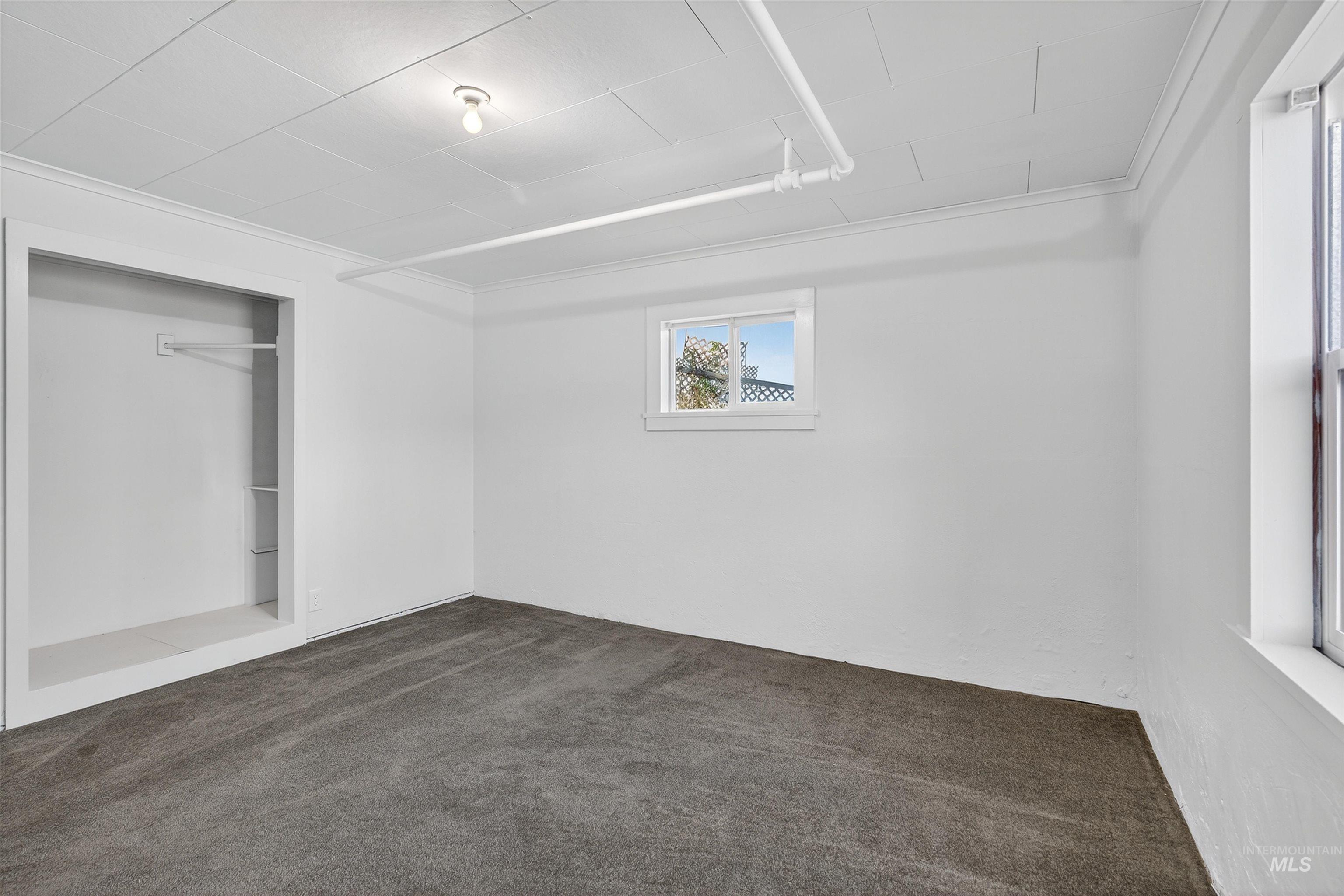 164 State Street Juliaetta, ID 83535 - Photo 30 of 37 Unfurnished bedroom with dark carpet and a closet