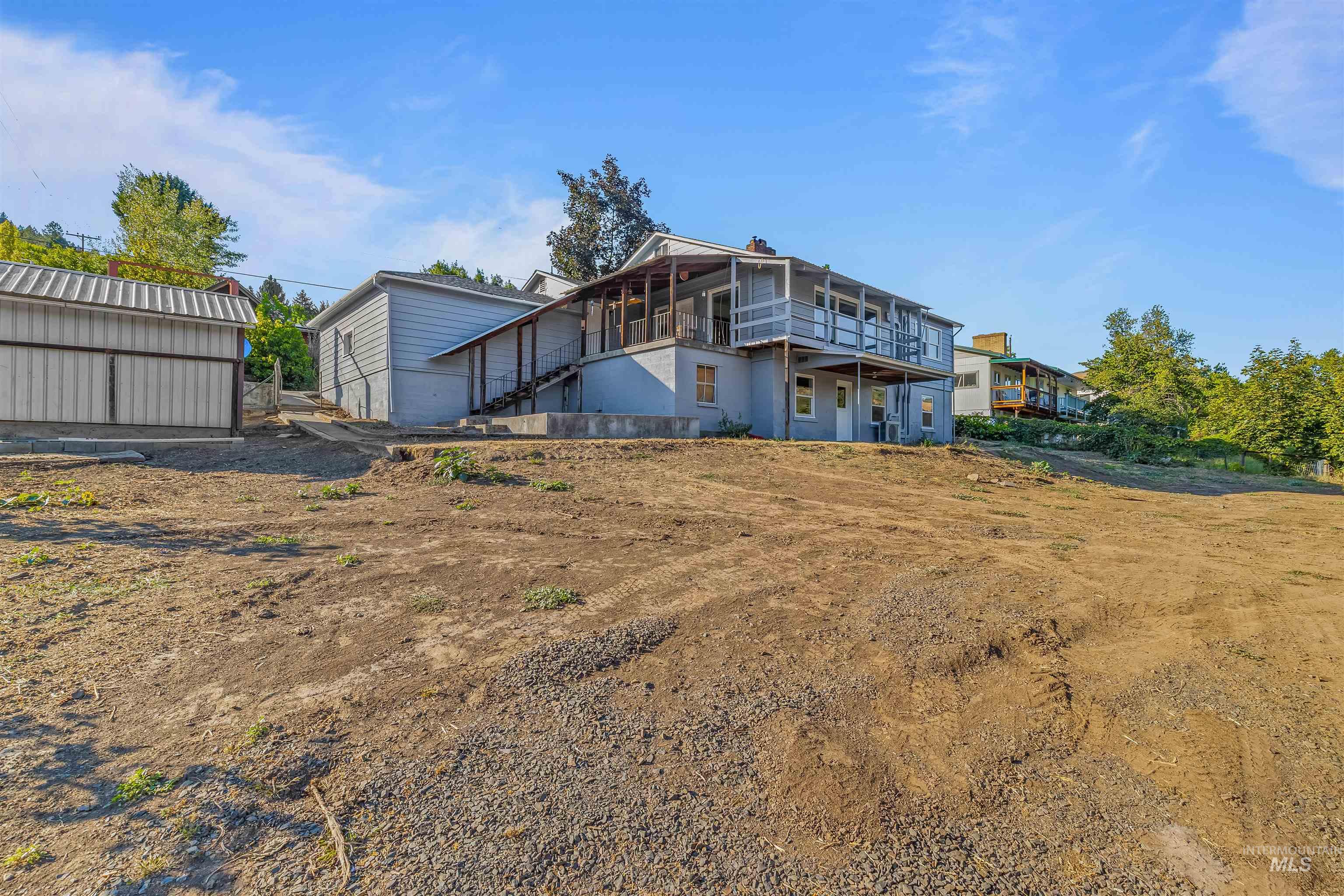 164 State Street Juliaetta, ID 83535 - Photo 31 of 37 Rear view of house featuring a wooden deck, stairs, and an outdoor structure