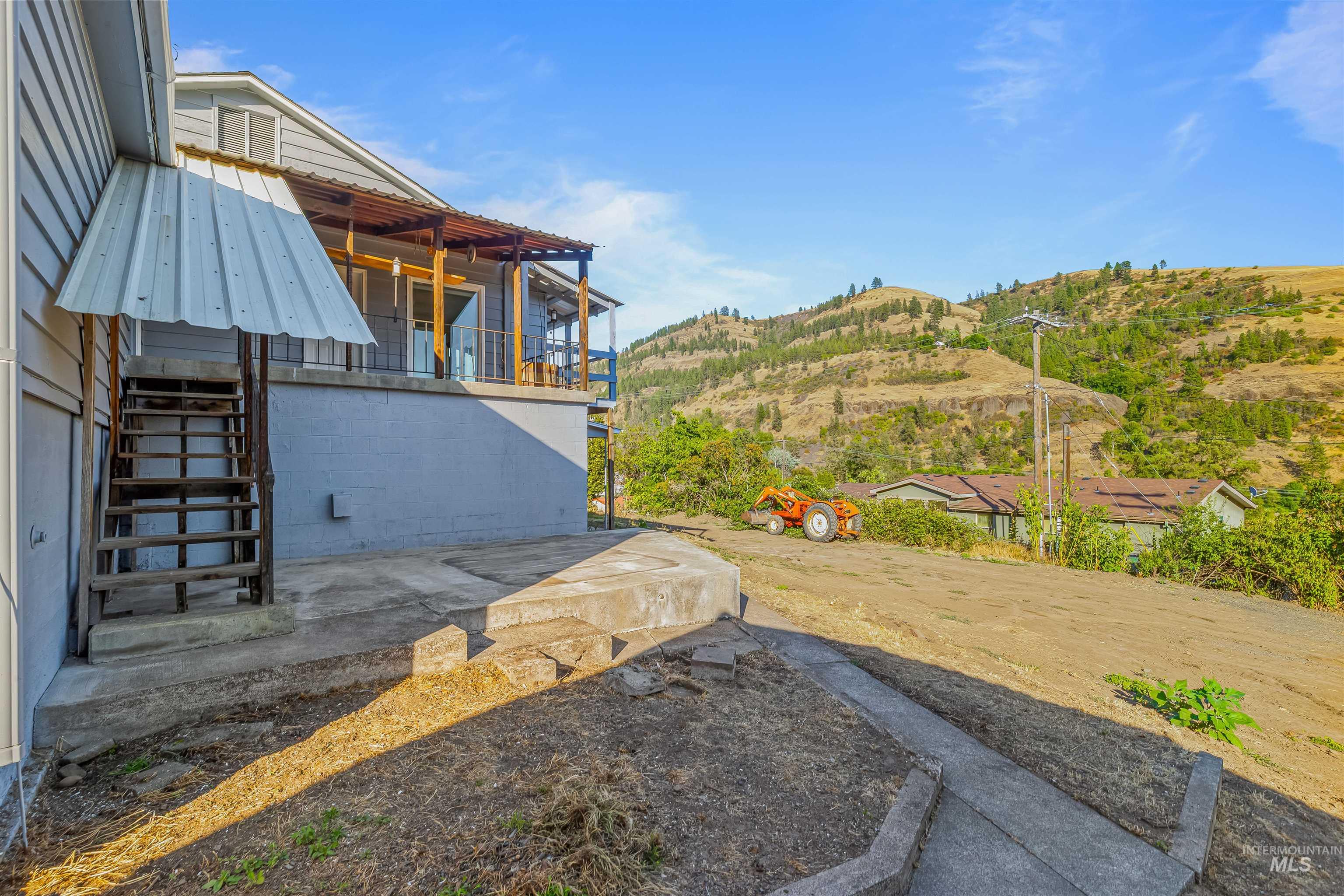 164 State Street Juliaetta, ID 83535 - Photo 35 of 37 View of yard featuring stairs, a patio, a balcony, and a mountain view