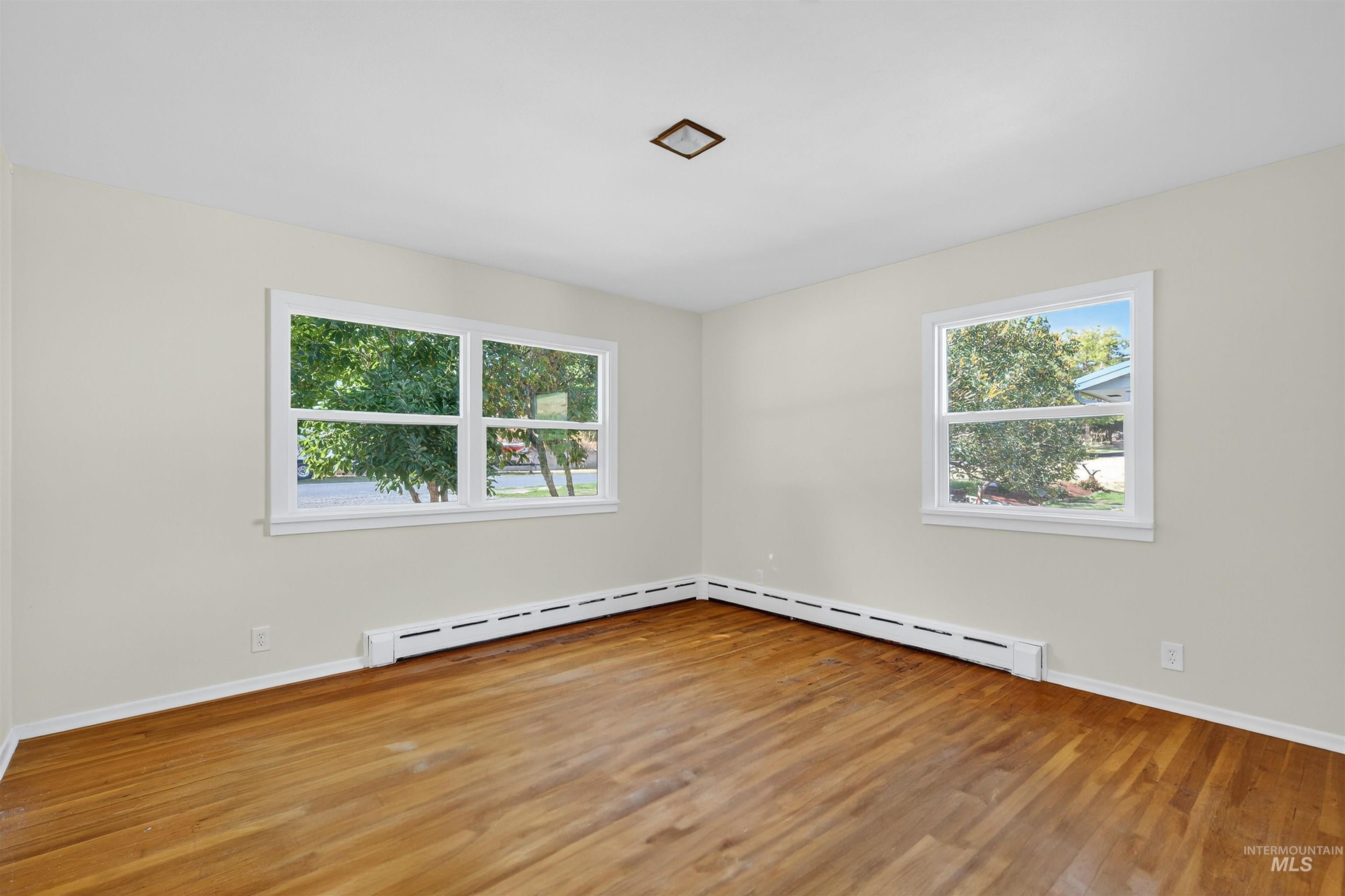 164 State Street Juliaetta, ID 83535 - Photo 9 of 37 Unfurnished room featuring light wood finished floors and a baseboard heating unit