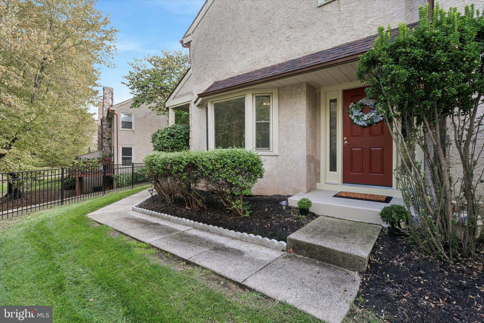 82 Bunker Hill Court, Unit 82 Wayne, PA 19087 - Photo 1 of 23 a front view of a house with garden