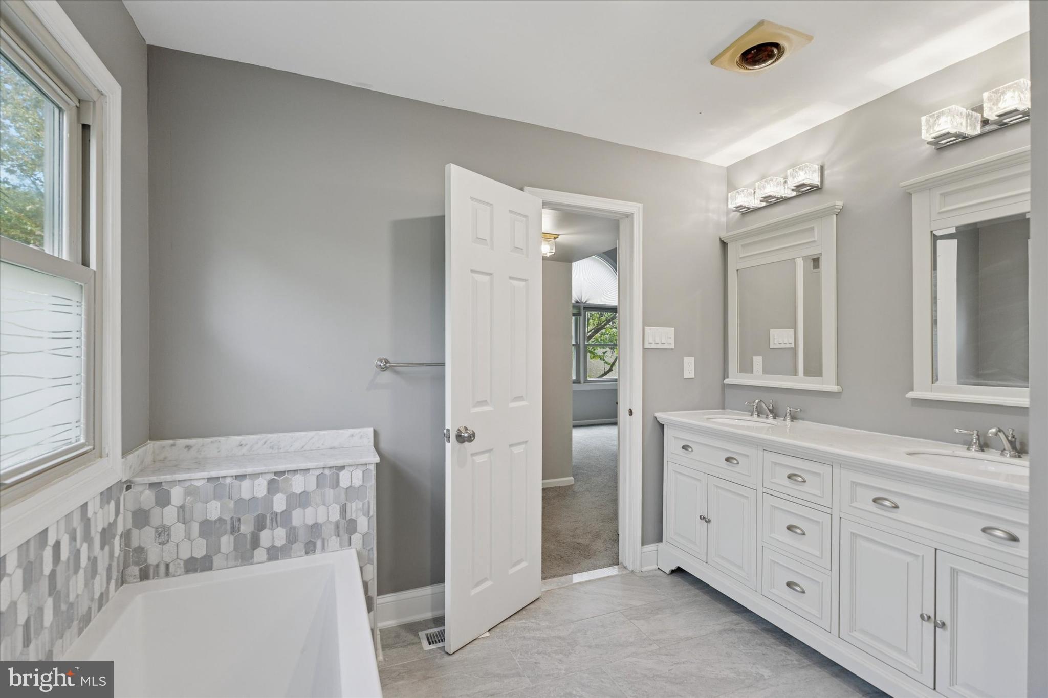 82 Bunker Hill Court, Unit 82 Wayne, PA 19087 - Photo 17 of 23 a spacious bathroom with a double vanity sink a mirror and a shower