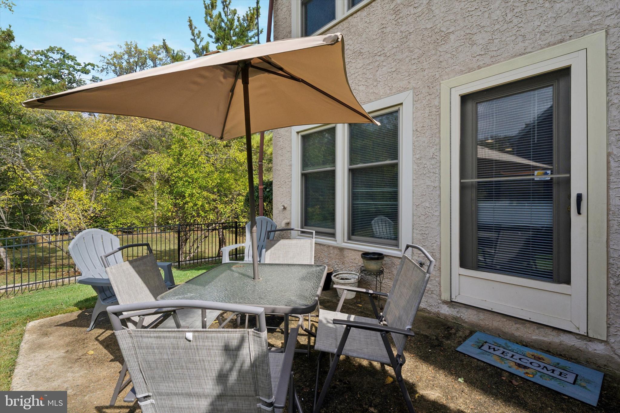 82 Bunker Hill Court, Unit 82 Wayne, PA 19087 - Photo 22 of 23 a patio with table and chairs