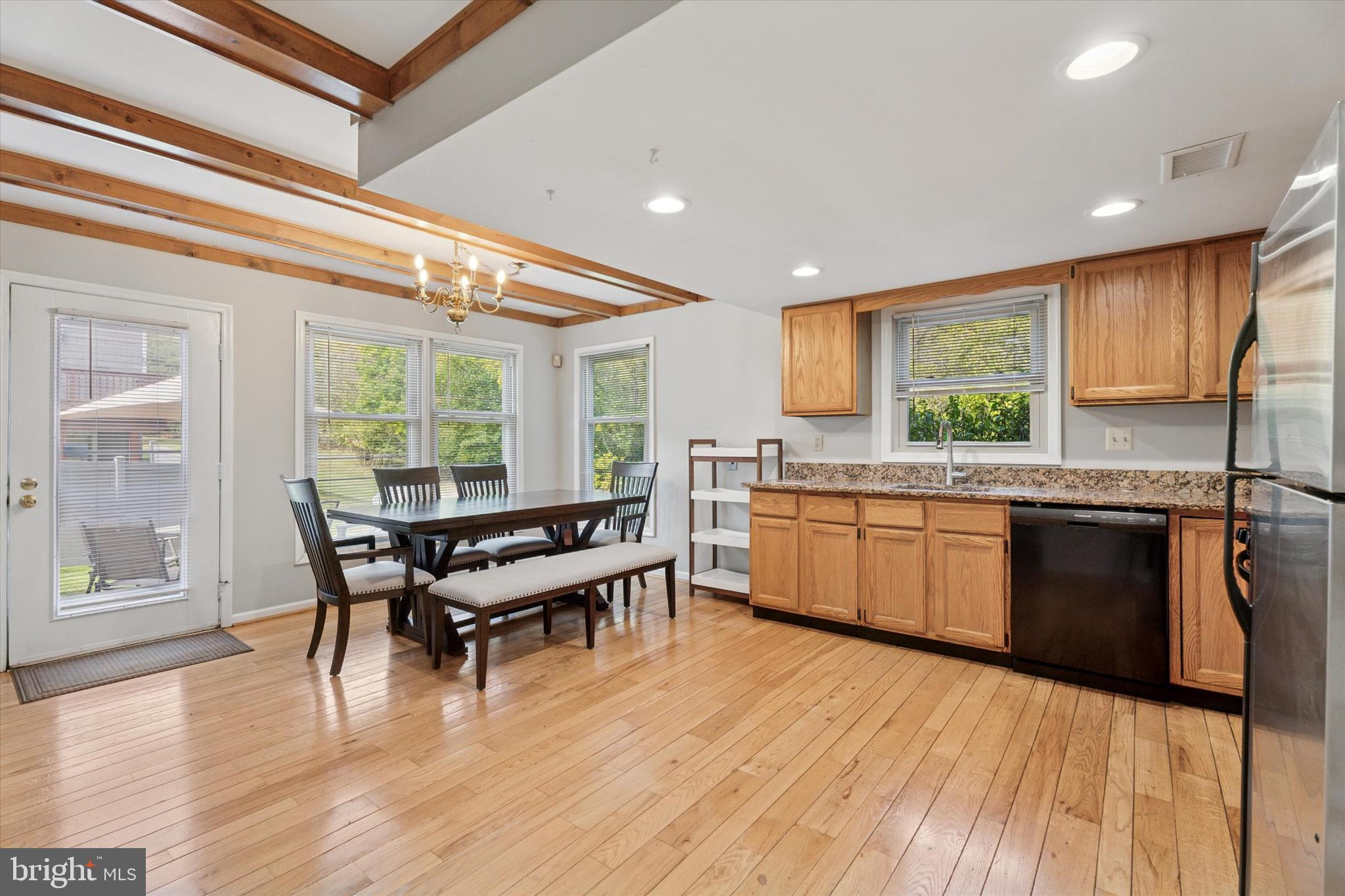 82 Bunker Hill Court, Unit 82 Wayne, PA 19087 - Photo 4 of 23 a kitchen with a wooden table and chairs