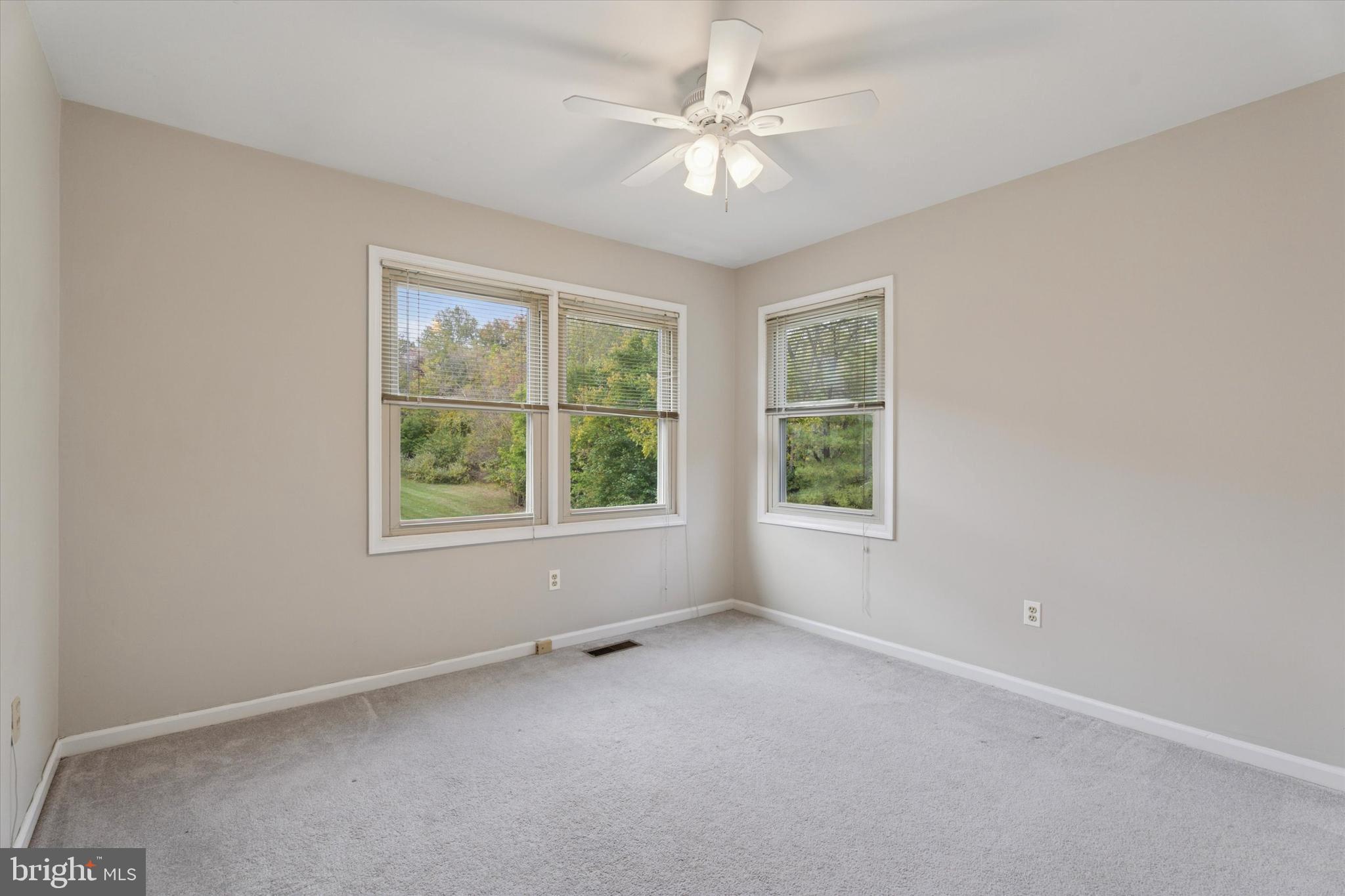 82 Bunker Hill Court, Unit 82 Wayne, PA 19087 - Photo 10 of 23 an empty room with windows and ceiling fan