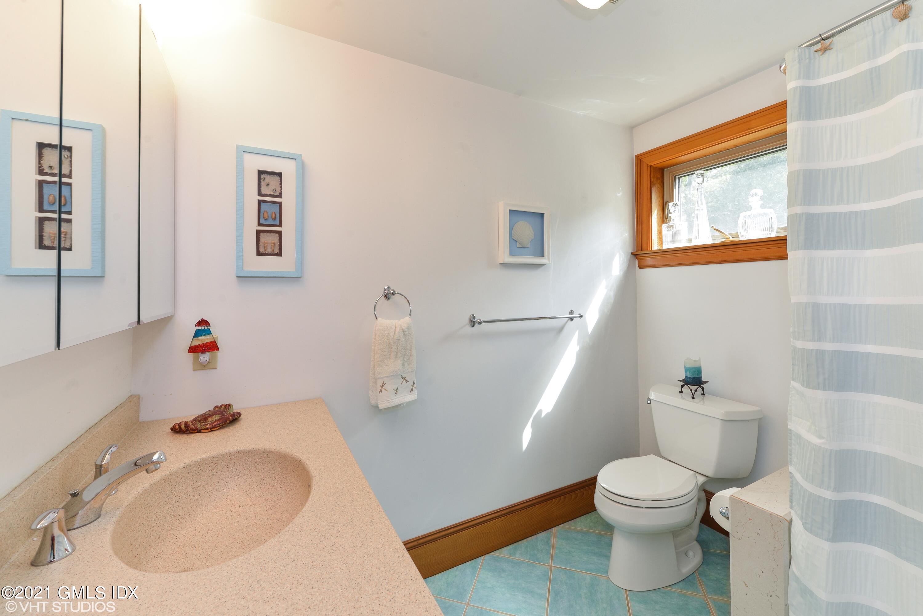 78 Long Meadow Road Riverside, CT 06878 - Photo 11 of 18 a bathroom with a sink a toilet and a mirror