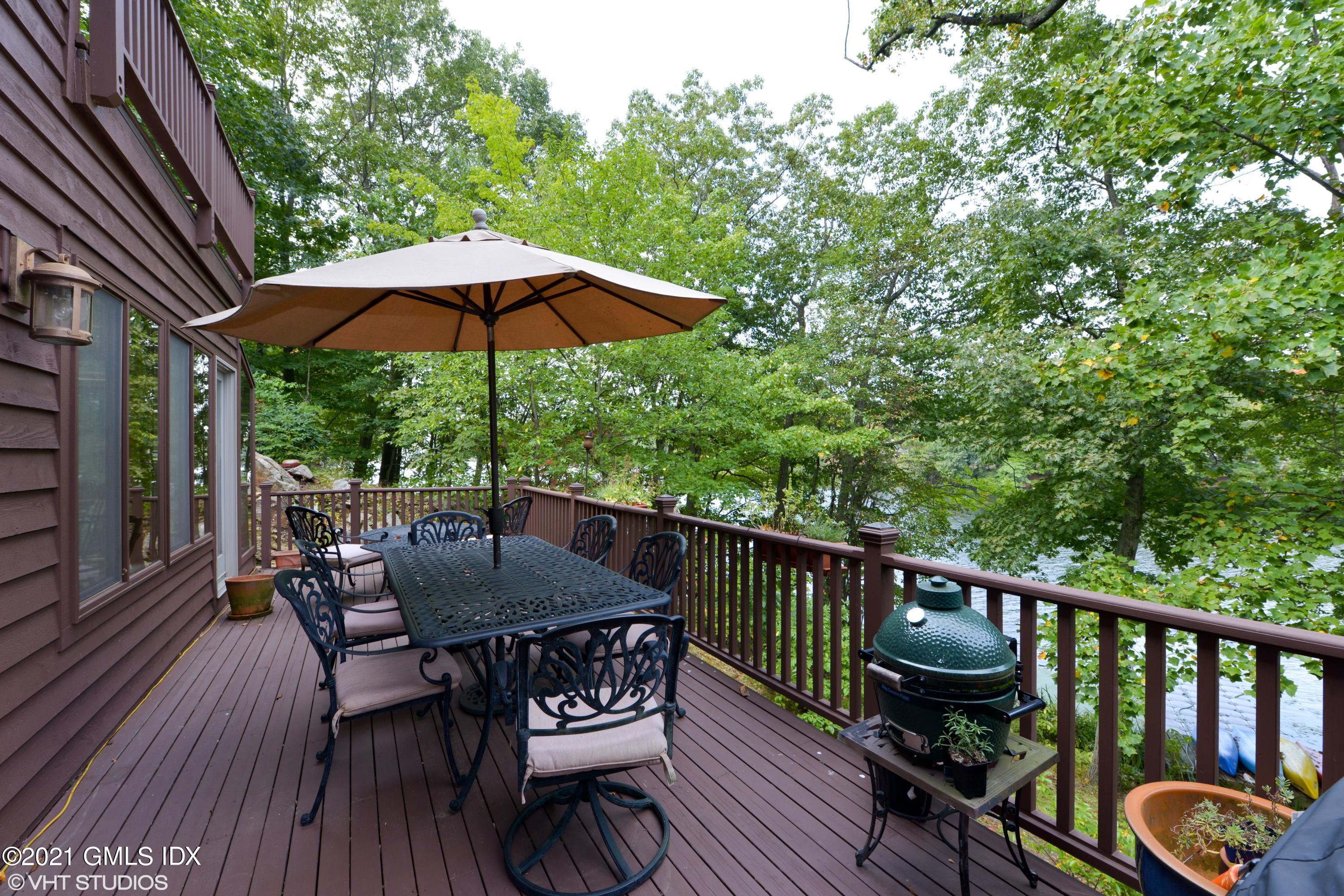 78 Long Meadow Road Riverside, CT 06878 - Photo 13 of 18 a view of balcony with furniture and umbrella