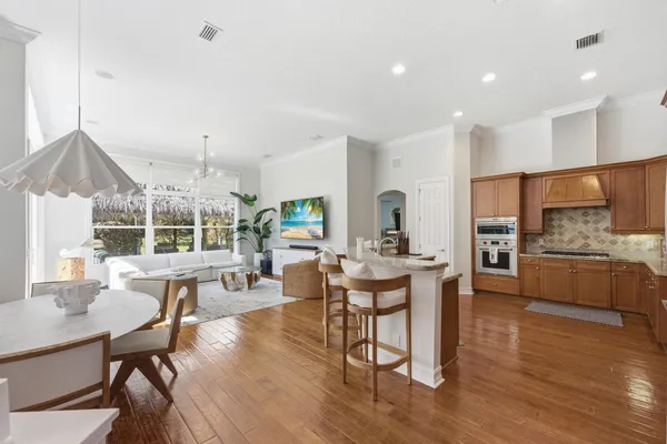 a view of a dining room with furniture and wooden floor
