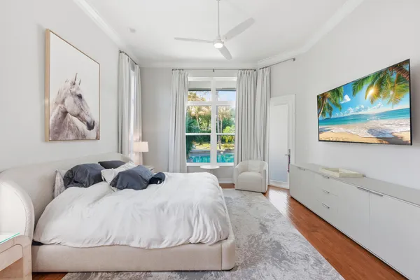 a bedroom with a bed and a window with rug
