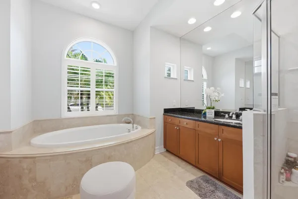 a bathroom with a glass shower door and a sink