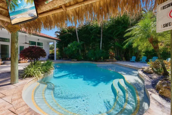 a swimming pool with outdoor seating and yard