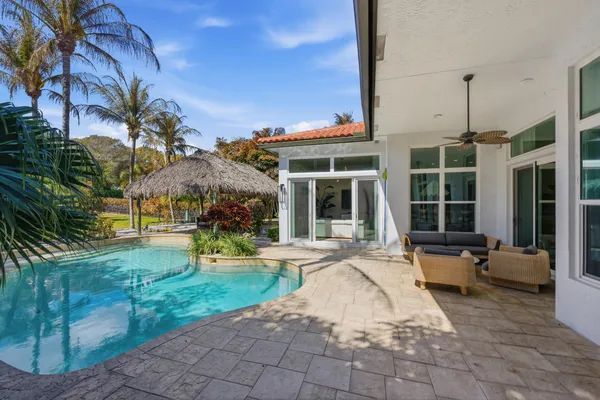 an aerial view of house with yard swimming pool and outdoor seating