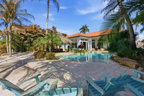an aerial view of house with yard and swimming pool