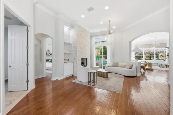 a kitchen with stainless steel appliances granite countertop wooden floors and white cabinets