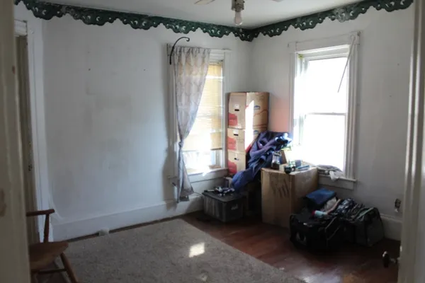a bathroom with a white toilet and a shower curtain