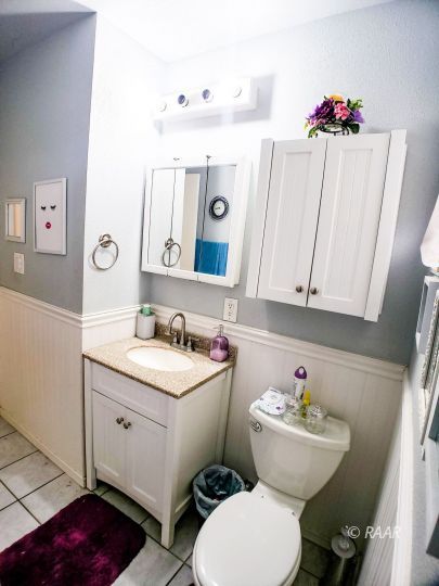 256 North Norma Street Ridgecrest, CA 93555 - Photo 24 of 35 a bathroom with a toilet sink and mirror