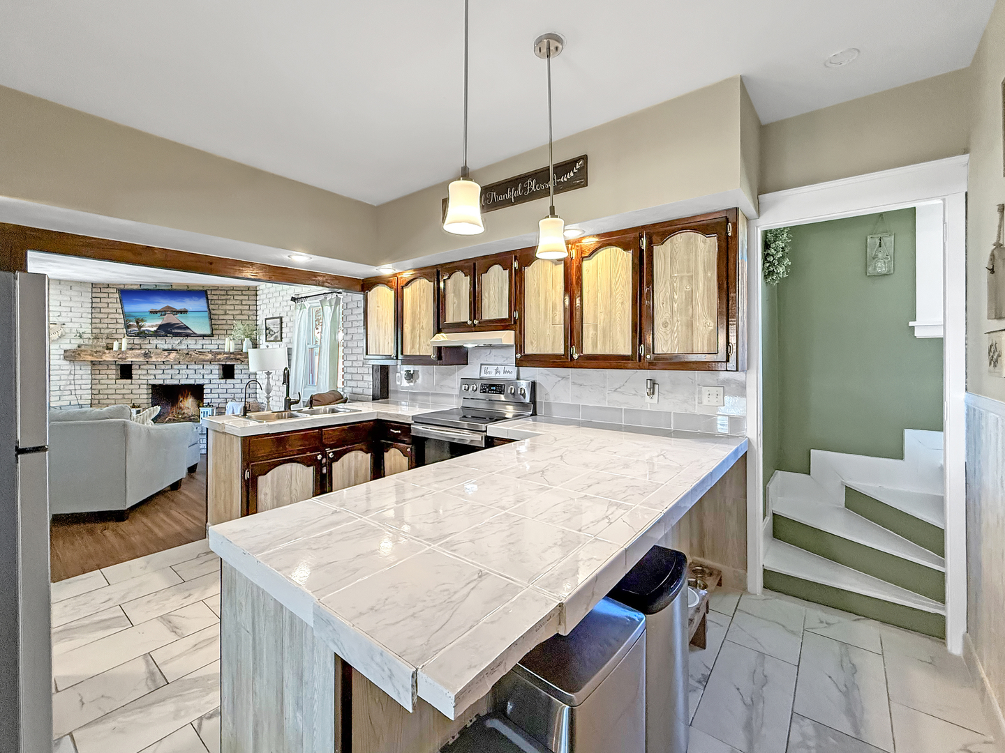 4895 West Stephenson St Road Freeport, IL 61032 - Photo 25 of 66 a kitchen with a stove a counter top space and a view of living room