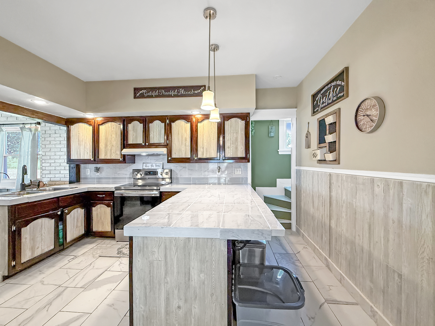 4895 West Stephenson St Road Freeport, IL 61032 - Photo 27 of 66 a kitchen with a table chairs sink and cabinets