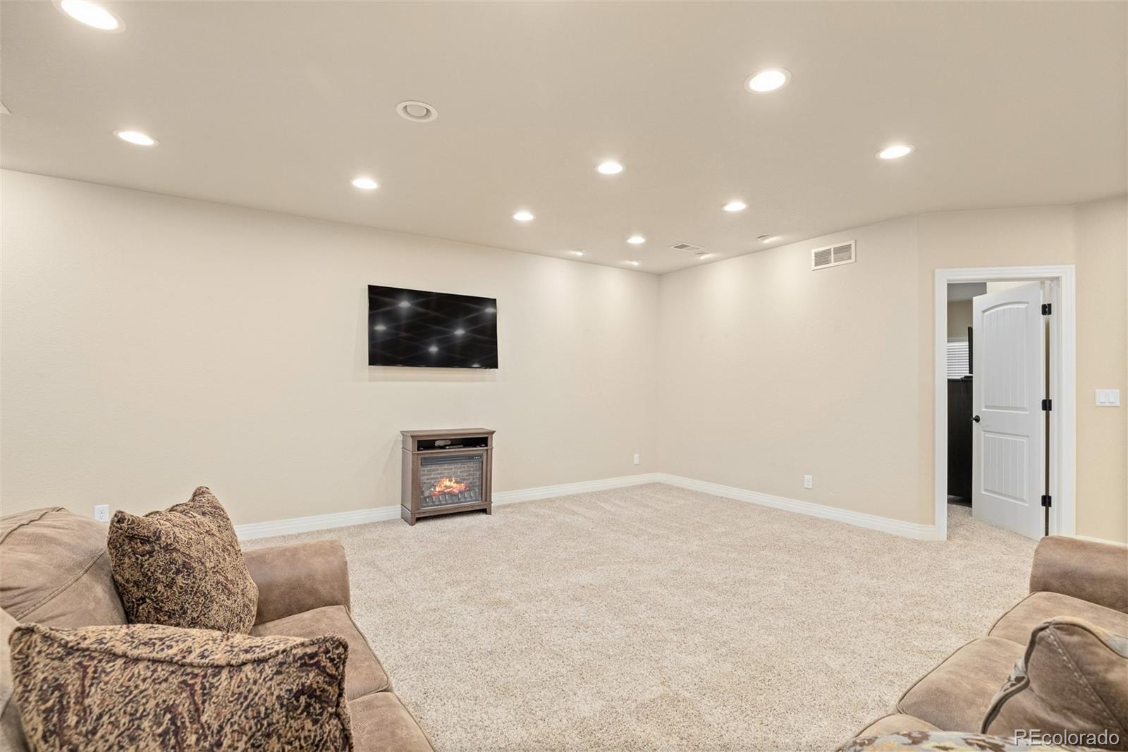 41865 East Muirfield Loop Elizabeth, CO 80107 - Photo 31 of 50 a living room with furniture and a flat screen tv