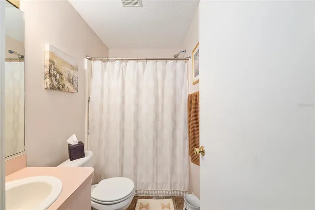 a white toilet sitting next to a bathroom sink