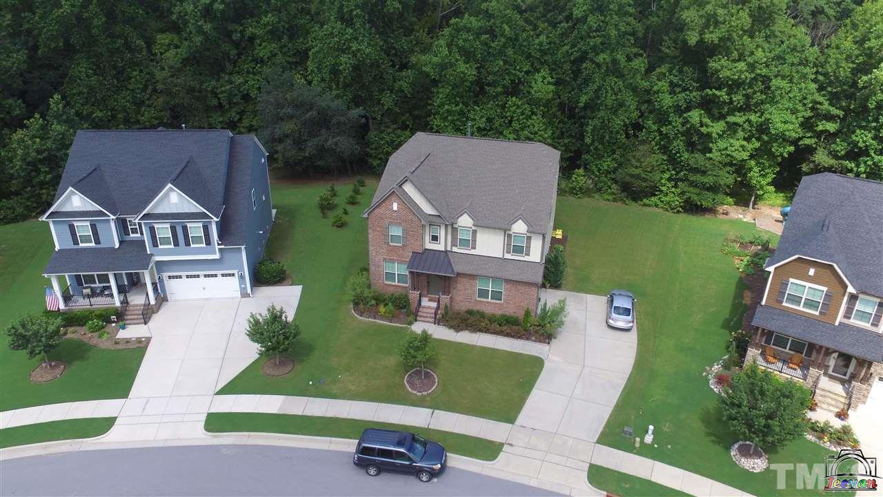 an aerial view of a house with outdoor space patio and trees all around