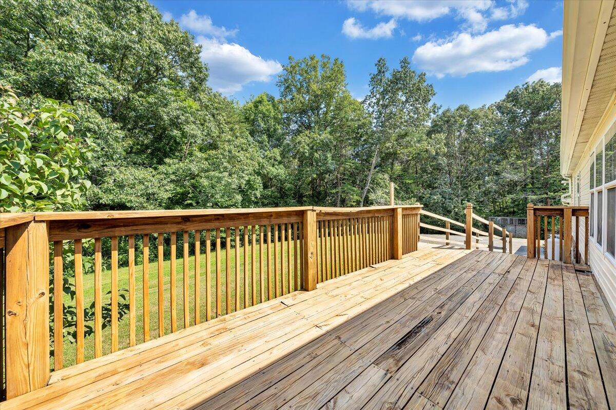 1102 Thomasson Mill Road Goodview, VA 24095 - Photo 27 of 45 a balcony with wooden floor and fence