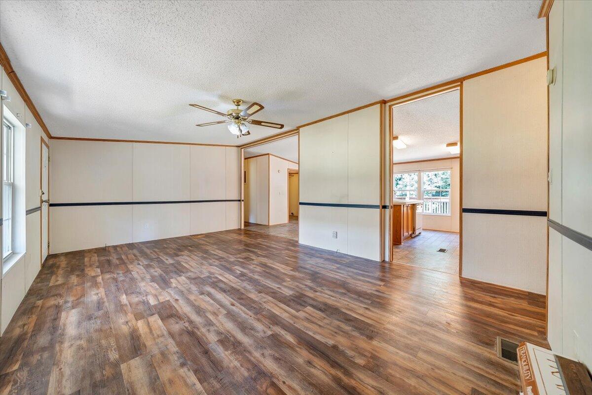1102 Thomasson Mill Road Goodview, VA 24095 - Photo 3 of 45 a view of empty room with wooden floor and fan