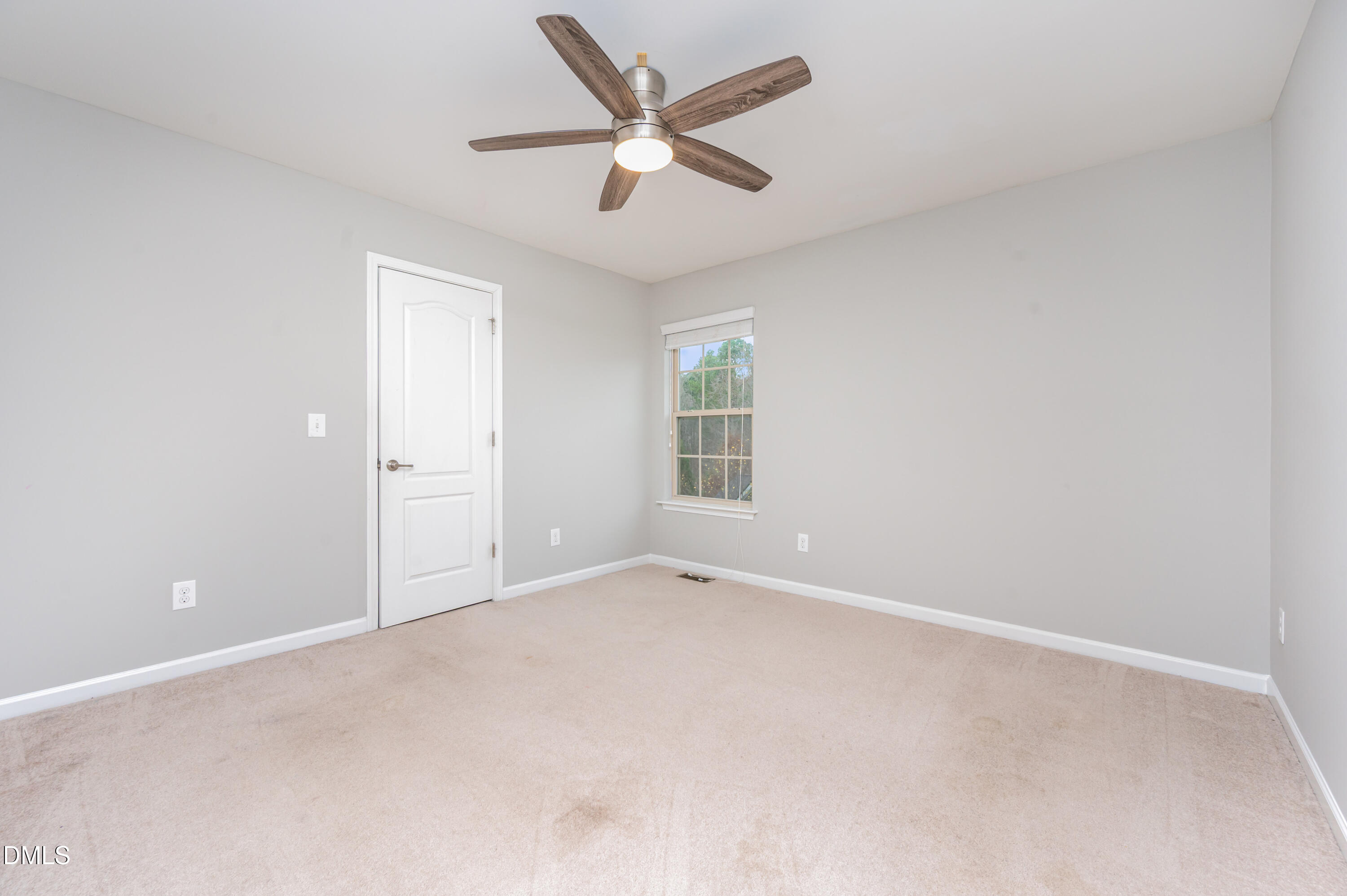 1956 Lazio Lane Apex, NC 27502 - Photo 30 of 47 an empty room with ceiling fan and window