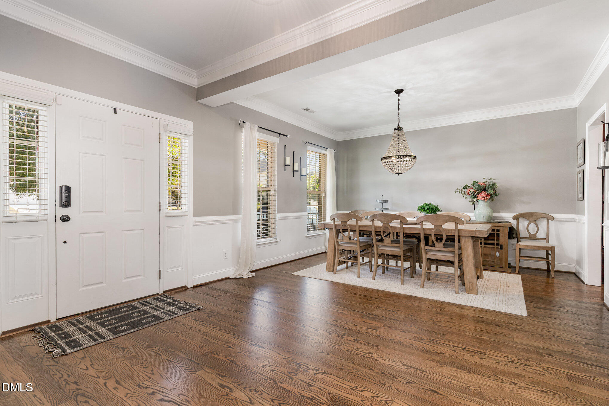 1956 Lazio Lane Apex, NC 27502 - Photo 7 of 47 a dining room with wooden floor a chandelier a wooden table and chairs