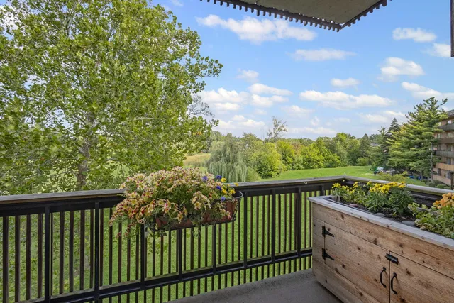 a balcony with trees in the back yard