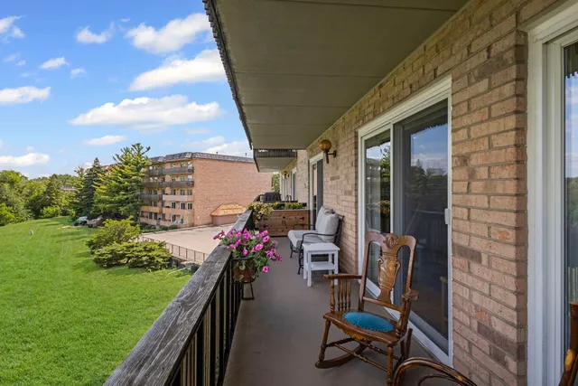 a view of a porch with furniture and garden