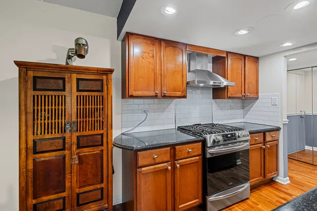 a kitchen with stainless steel appliances granite countertop a stove and a sink
