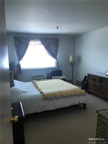 a bedroom with bed and window
