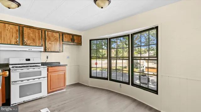 a kitchen with stainless steel appliances granite countertop a stove sink and cabinets
