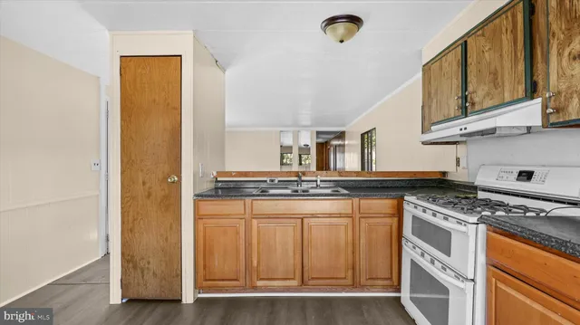 a kitchen with stainless steel appliances granite countertop a stove and a refrigerator