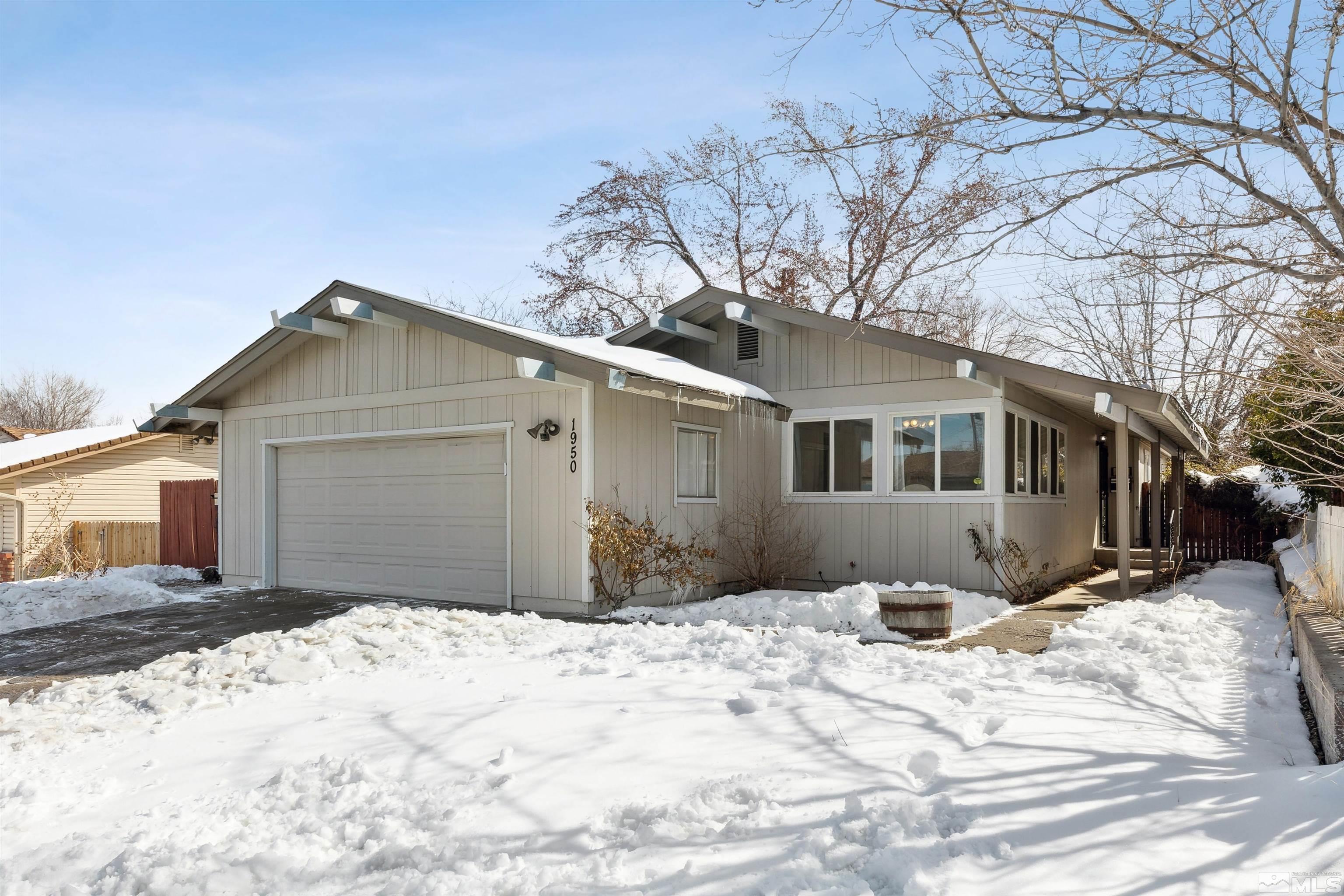 1950 Prince Way Reno, NV 89503 - Photo 1 of 17 a front view of a house with a yard covered in snow