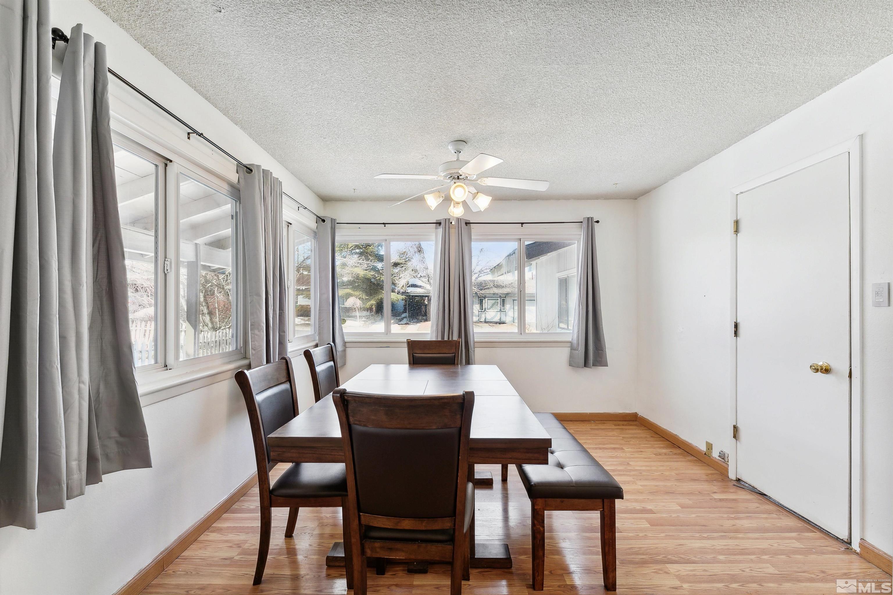 1950 Prince Way Reno, NV 89503 - Photo 11 of 17 a view of a dining room with furniture a chandelier and wooden floor