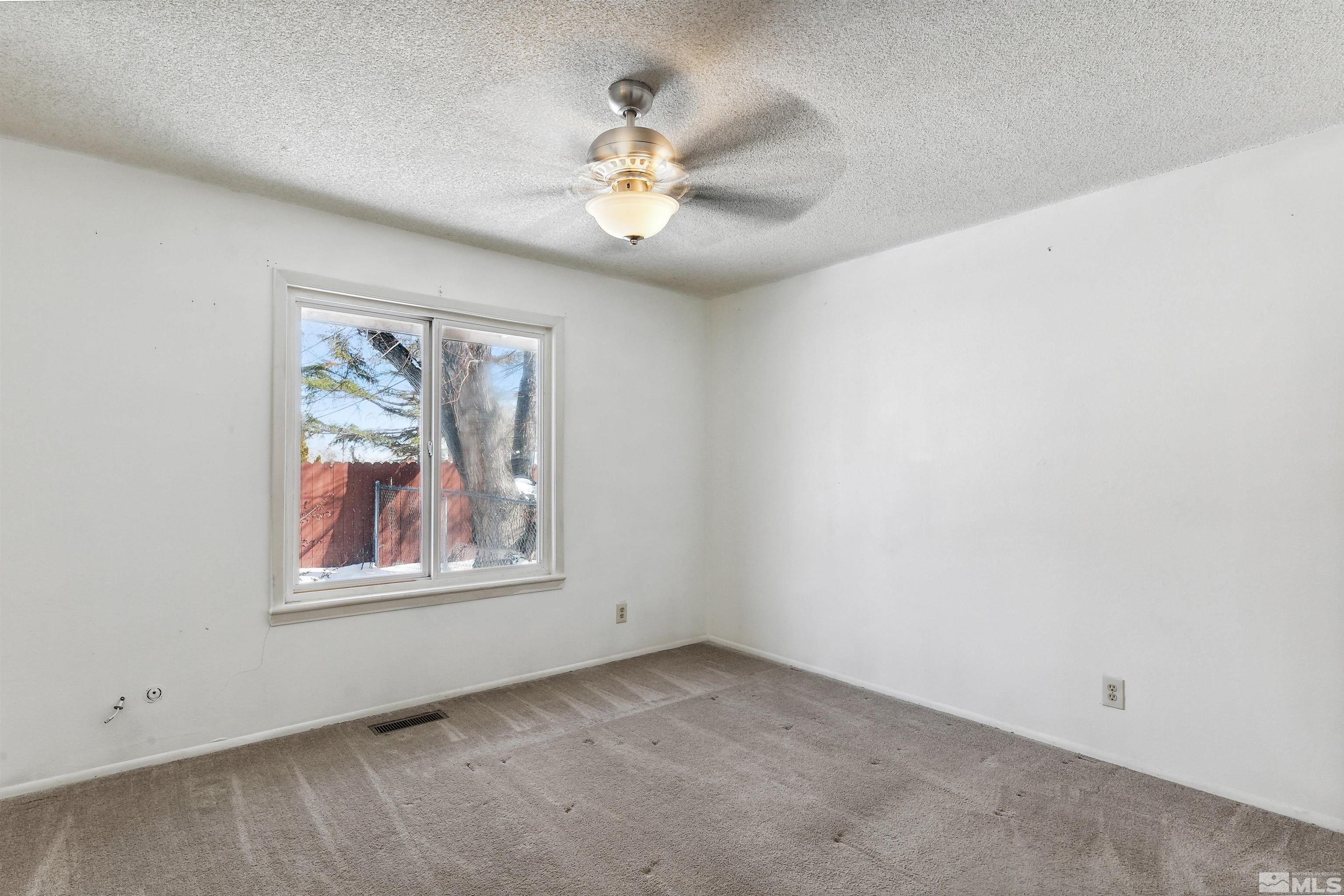 1950 Prince Way Reno, NV 89503 - Photo 15 of 17 an empty room with windows and chandelier fan