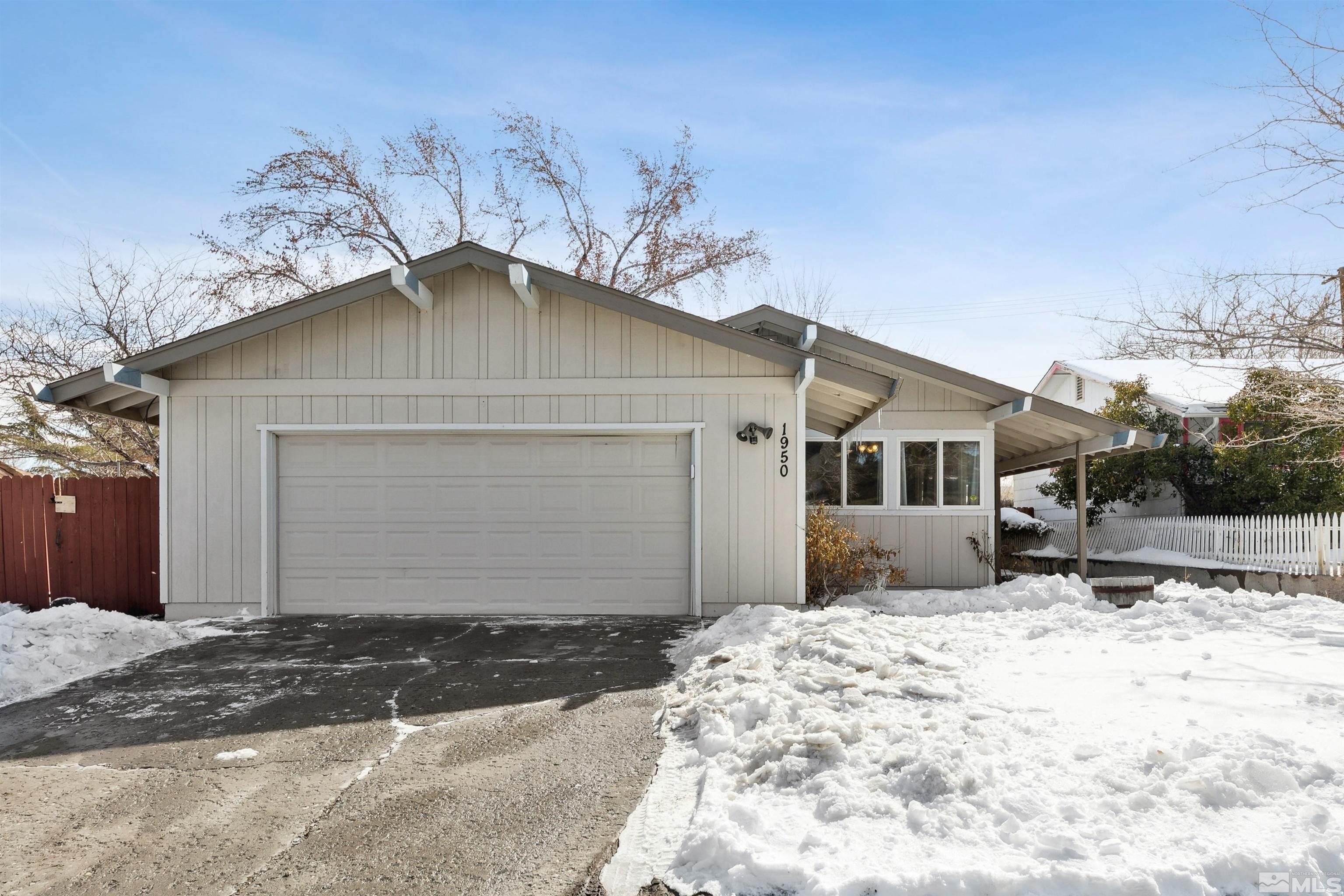 1950 Prince Way Reno, NV 89503 - Photo 2 of 17 a front view of a house with a yard and garage