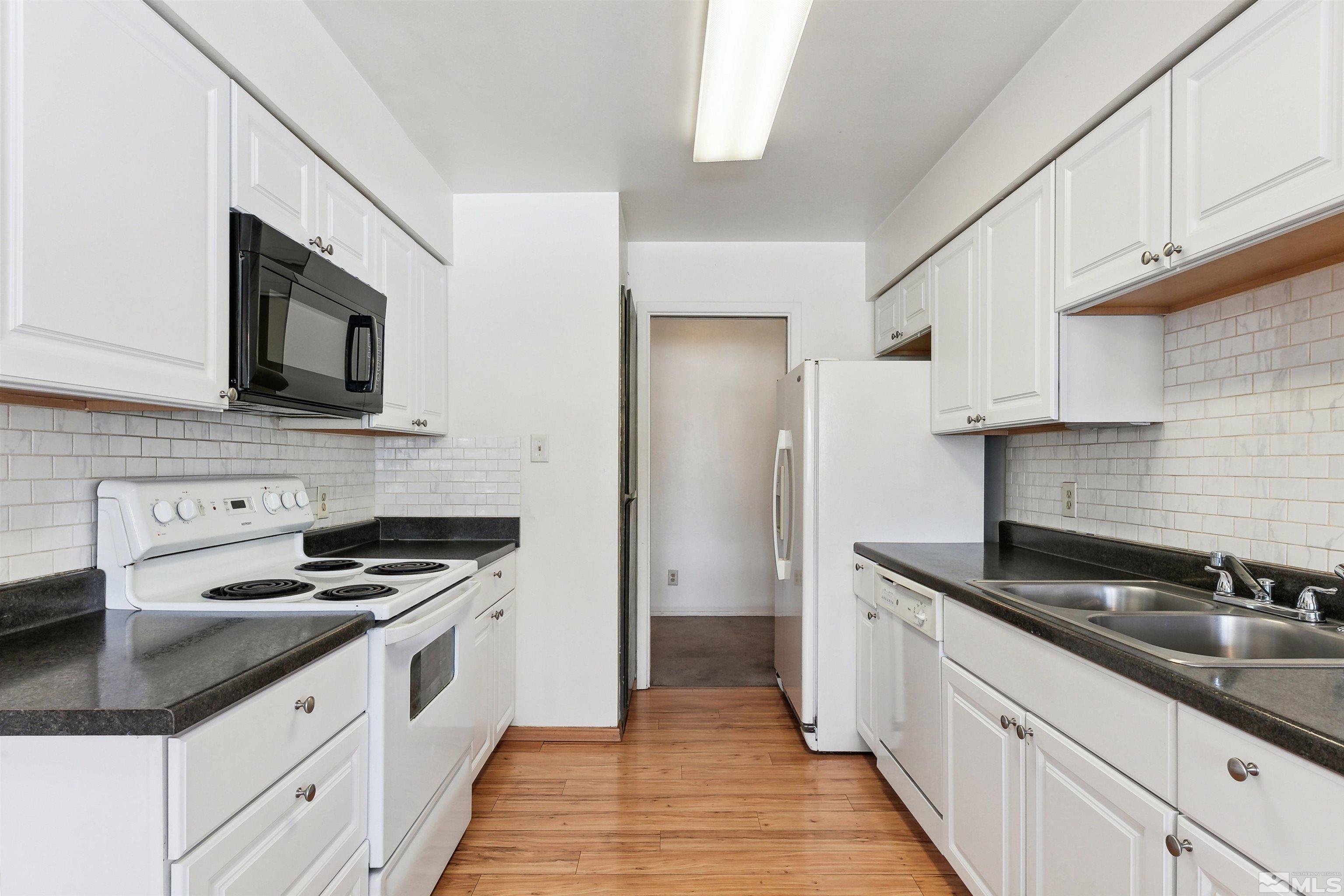 1950 Prince Way Reno, NV 89503 - Photo 8 of 17 a kitchen with granite countertop a sink a stove and cabinets