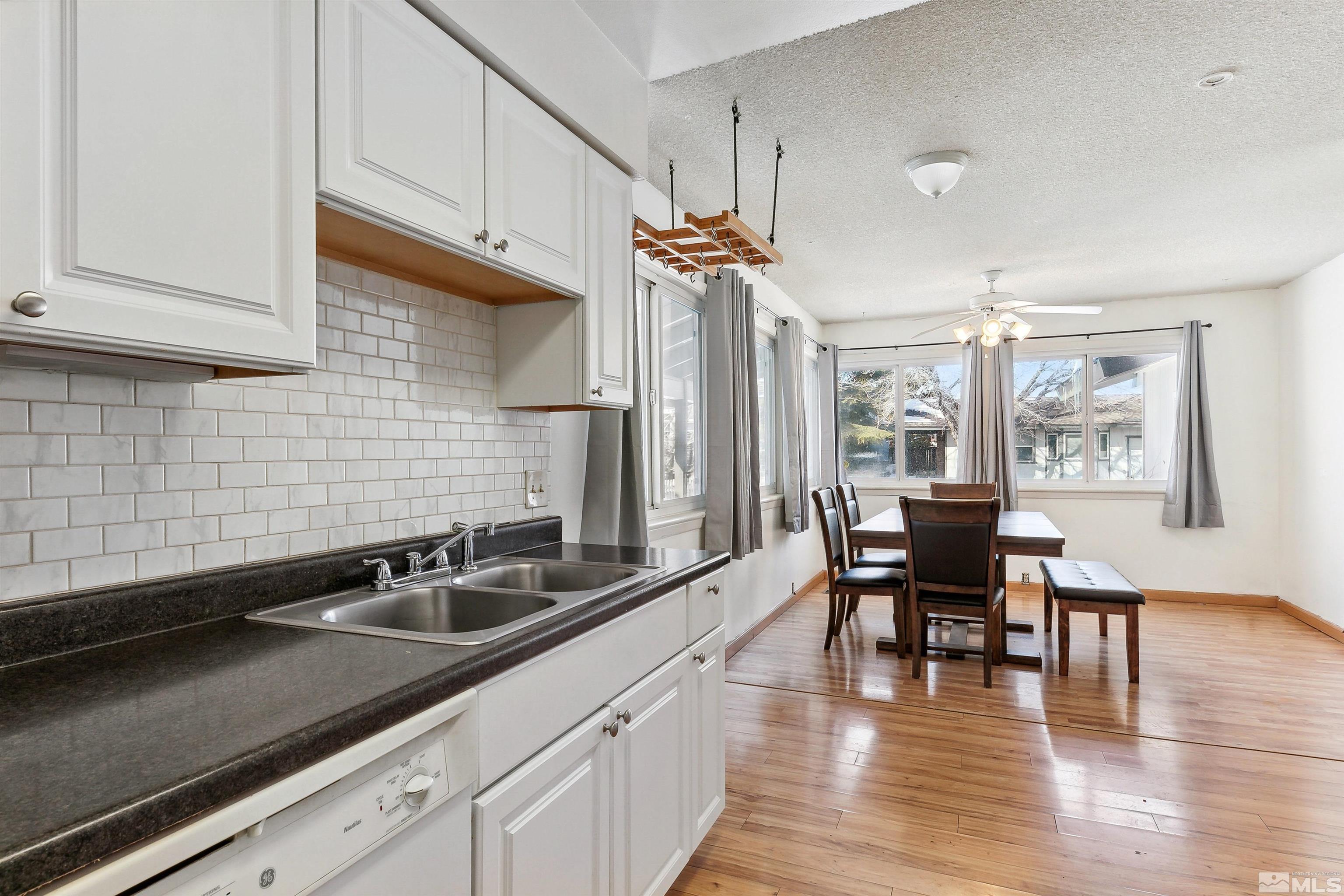 1950 Prince Way Reno, NV 89503 - Photo 10 of 17 a kitchen with stainless steel appliances a sink a table and chairs