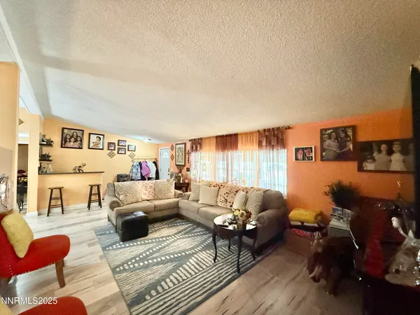 a living room with furniture and kitchen view