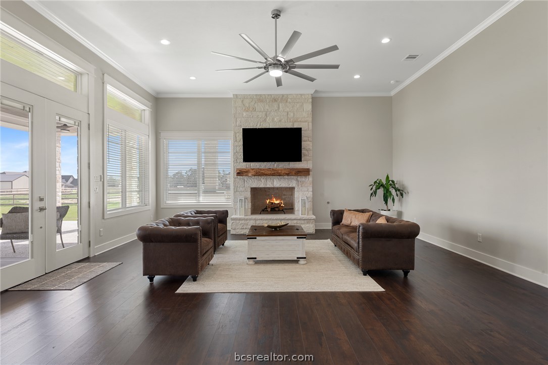 7844 Mathis Crk Drive Bryan, TX 77808 - Photo 11 of 48 a living room with furniture fireplace and a flat screen tv