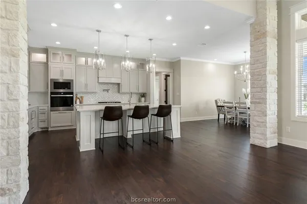 a dining room with furniture and wooden floor