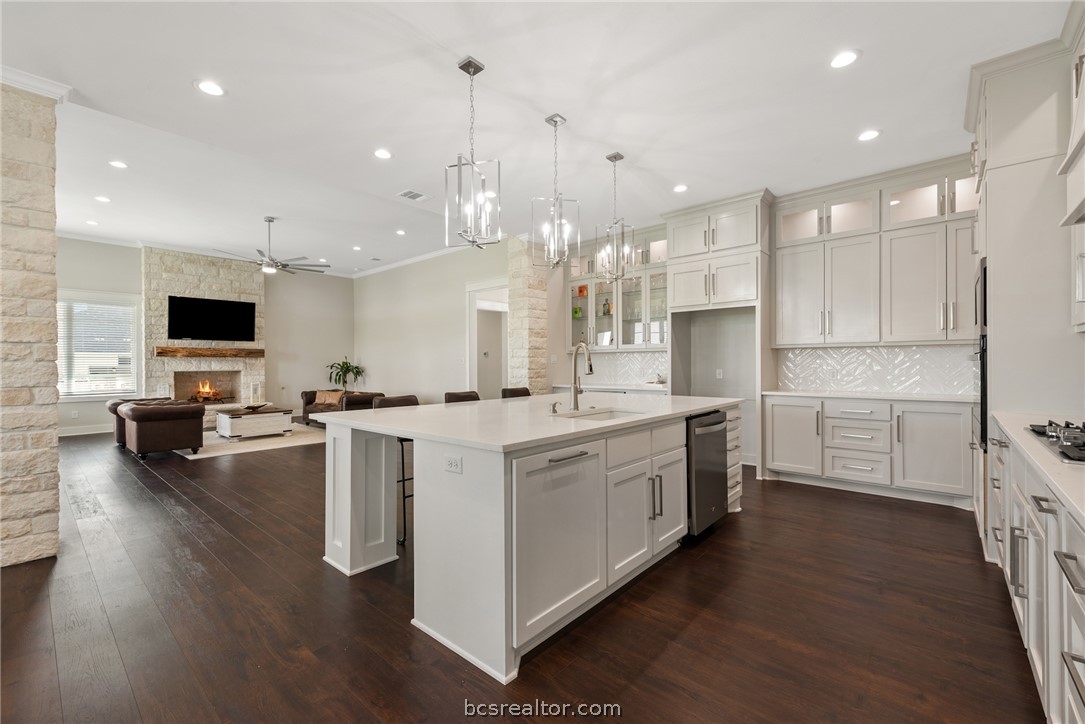 7844 Mathis Crk Drive Bryan, TX 77808 - Photo 15 of 48 a large kitchen with stainless steel appliances kitchen island granite countertop a large island in the center