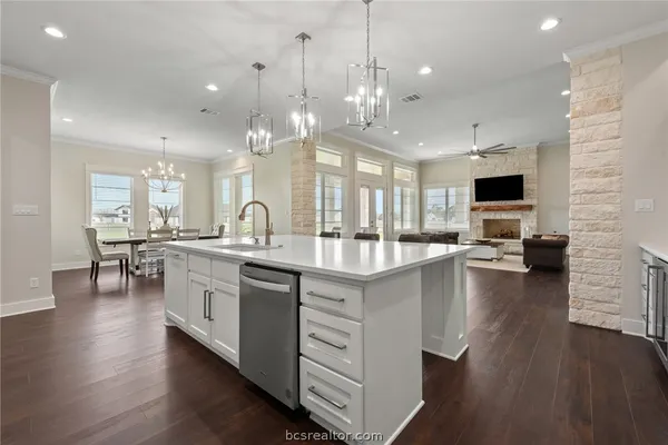 a large white kitchen with a large window