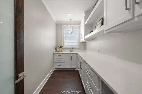 a kitchen with cabinets and window