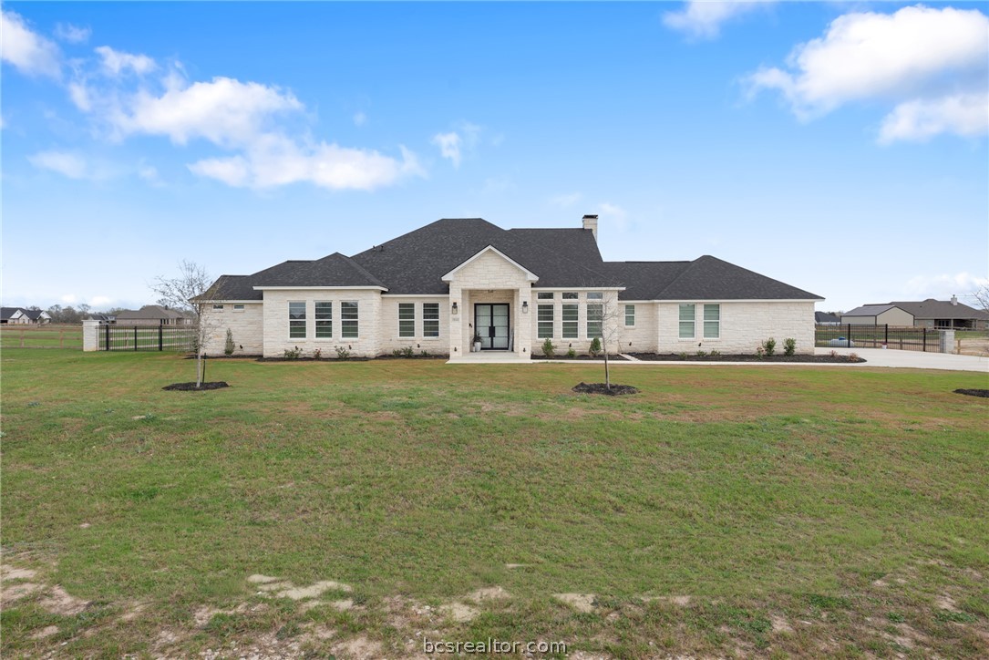 7844 Mathis Crk Drive Bryan, TX 77808 - Photo 2 of 48 a front view of a house with a garden